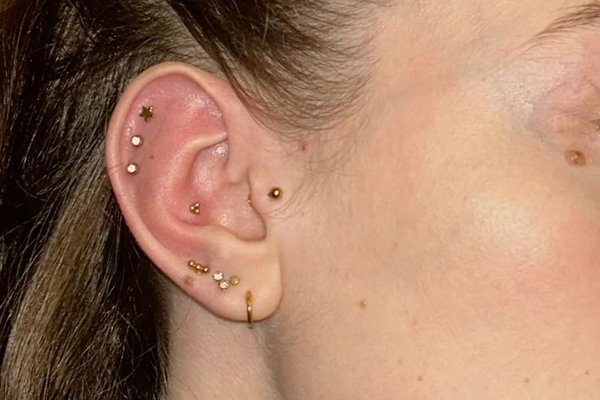 Triple helix piercing close-up with three studs