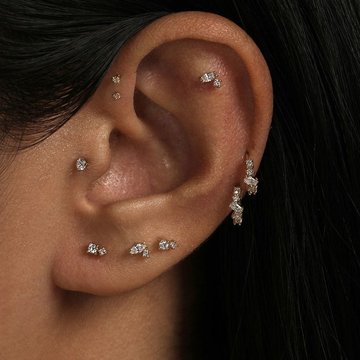 Forward helix and tragus piercing combination on ear