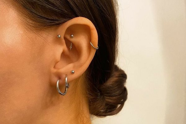 Forward helix piercing close-up with a simple stud