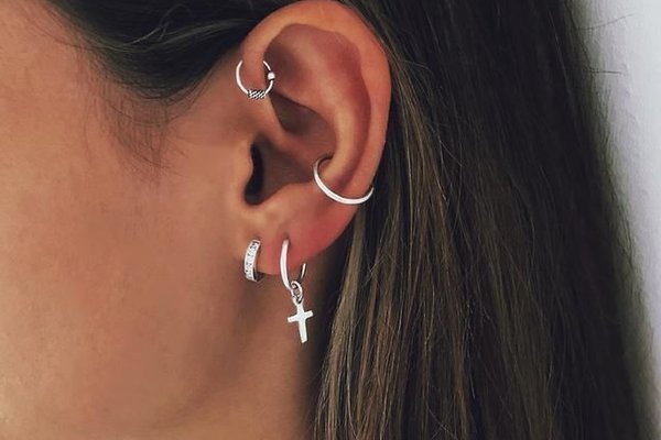 Woman with forward helix piercing and hoop