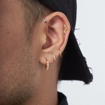 Mid helix piercing on male ear
