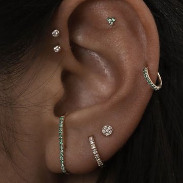 Woman smiling with mid helix piercing and crystals