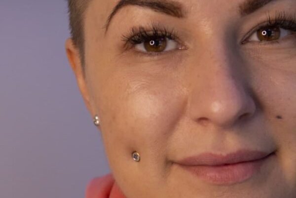 Female with paired mutya cheek piercing adorned with small studs