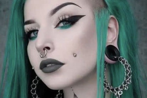 Symmetrical mutya cheek piercing on both cheeks