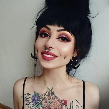Female with paired mutya cheek piercing adorned with small studs