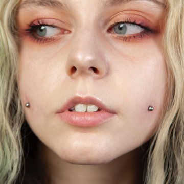 Concept image: cheek piercing hole with temporary jewelry for styling