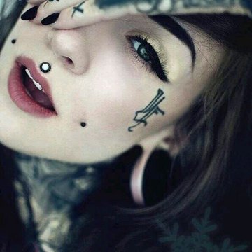 Artistic close-up of cheek dermal piercing with opal gem