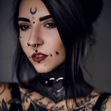 Symmetrical mutya cheek piercing on both cheeks
