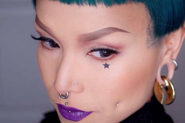 Creative cheek piercing stretch paired with earlobe jewelry