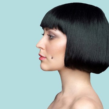 Side profile highlighting upper cheek piercing symmetry and placement
