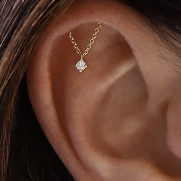 Artistic photo of hidden helix piercing with gemstone hoop