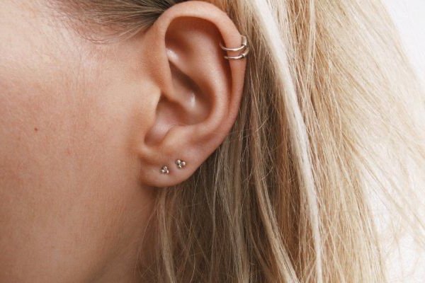 Close-up of freshly done double helix piercing