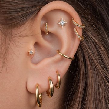 Stylish double helix piercing with mismatched jewelry