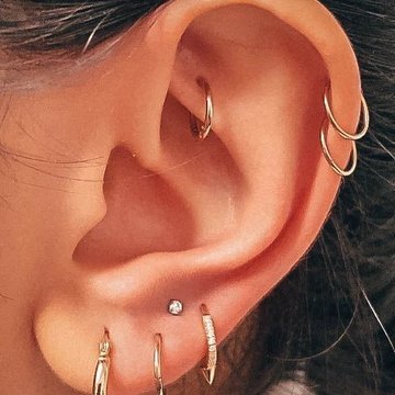 Double helix piercing with two silver hoops