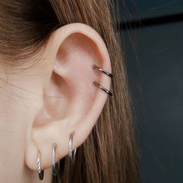 Double helix ear piercing combined with lobe studs