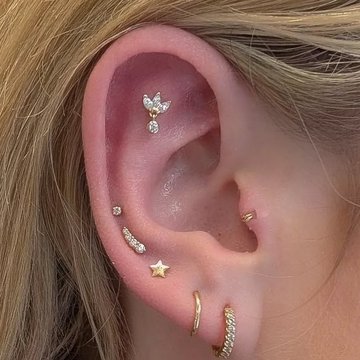 Flat helix piercing with rose gold jewelry