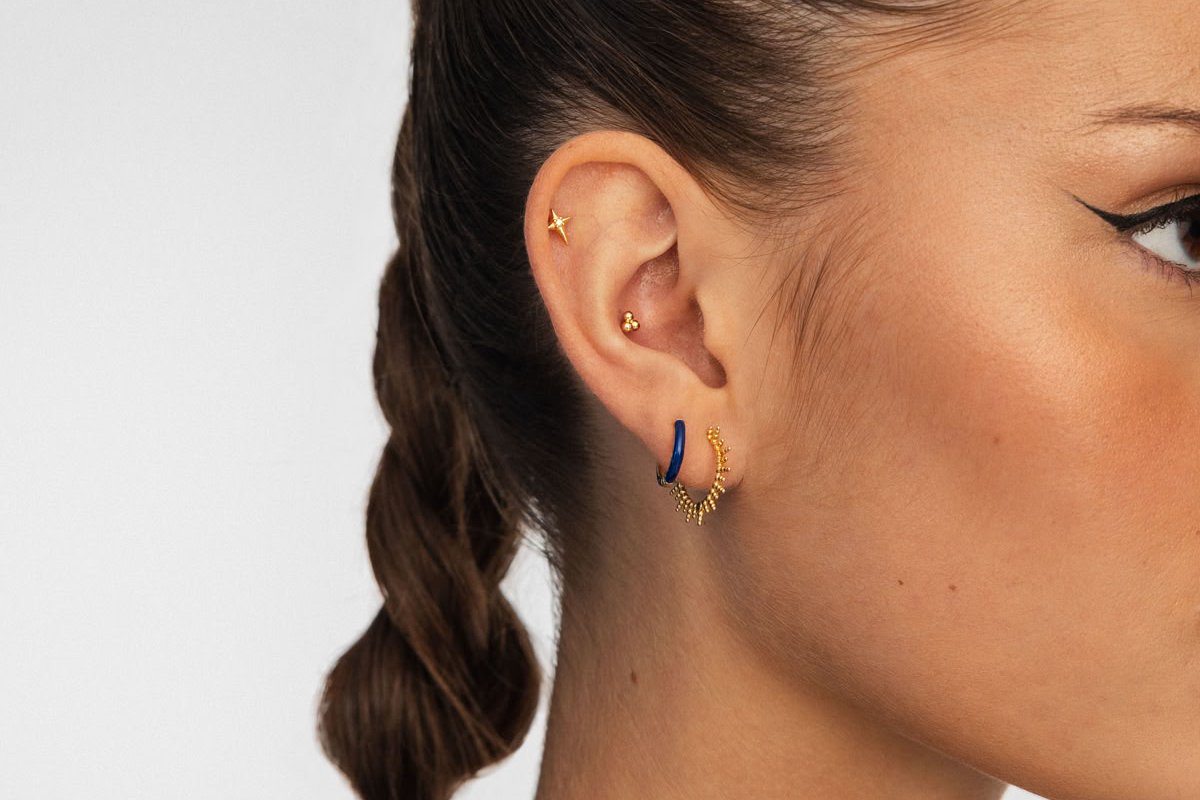 Flat helix piercing with gold stud