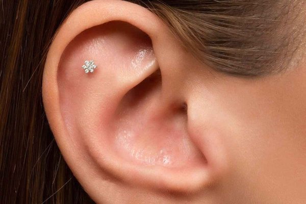 Stylish flat helix piercing with gemstone stud