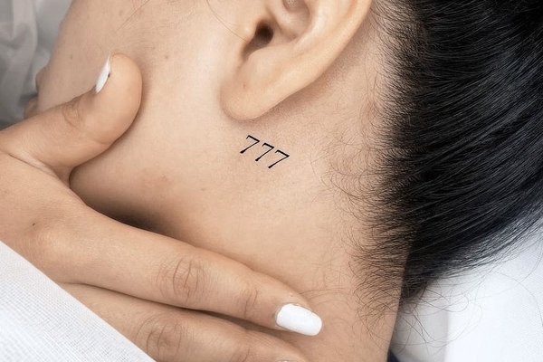 Tattoo 777 behind the ear