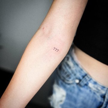 Tattoo 777 on the arm