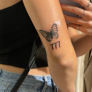 Tattoo 777 with a butterfly