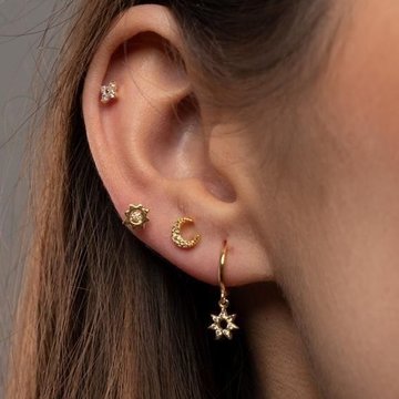 Double helix piercing close-up with studs