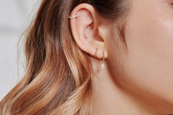 Double helix piercing with mismatched jewelry