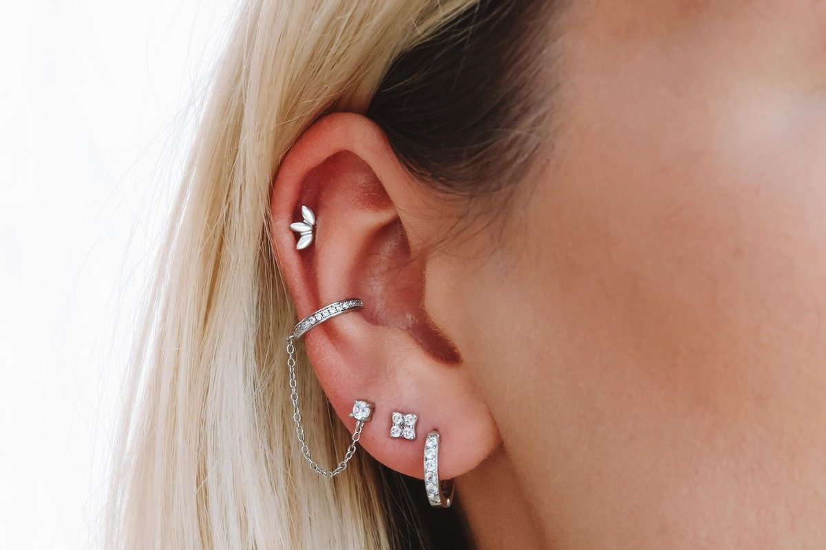 Double jewelry setup highlighting conch and mid helix piercings