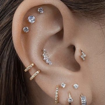 Double jewelry setup highlighting conch and mid helix piercings