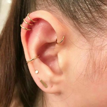 Triple helix piercing close-up with three studs