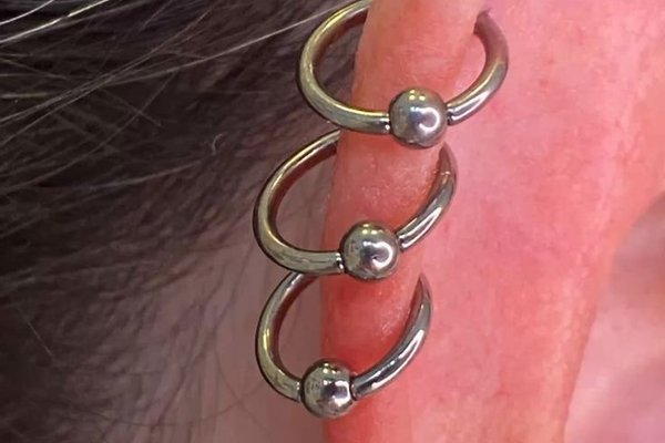 Triple helix piercing back view photo