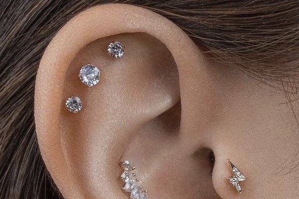 Triple forward helix piercing near tragus