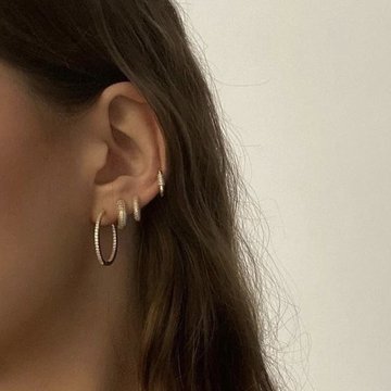 Low helix piercing with gold hoop jewelry