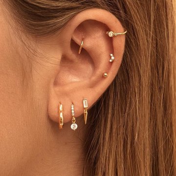 Elegant low helix piercing with mixed metal jewelry