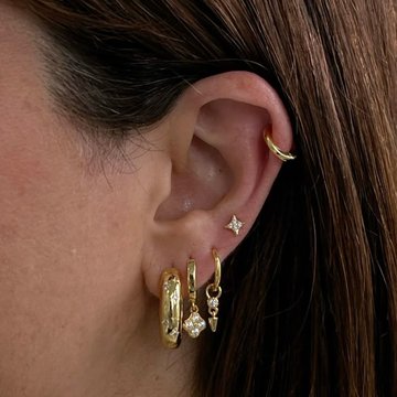 Low helix ear piercing with gemstone jewelry