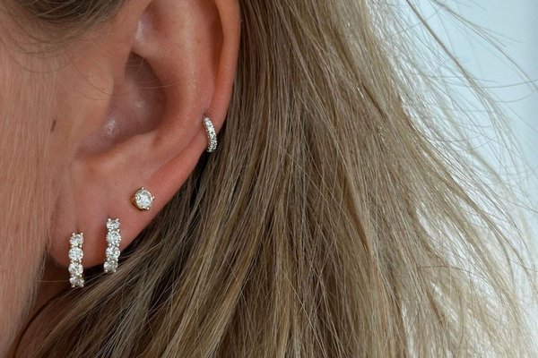 Low helix piercing combined with lobe earrings